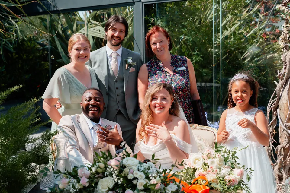 Sarah with a newly married couple and their wedding party